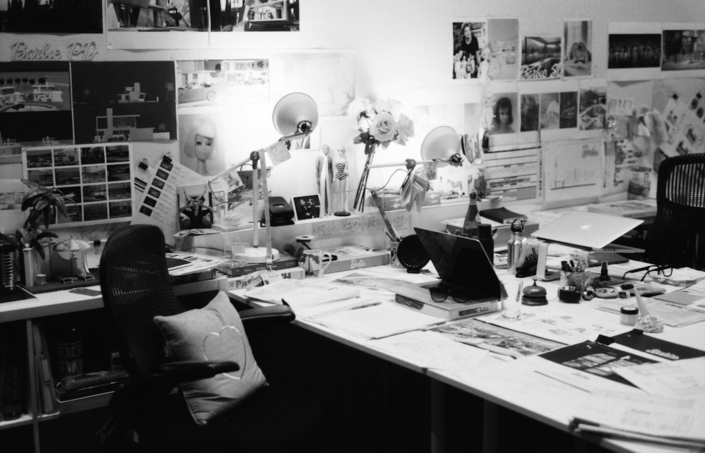 Event planners reviewing a floor plan and table layout in a quiet studio