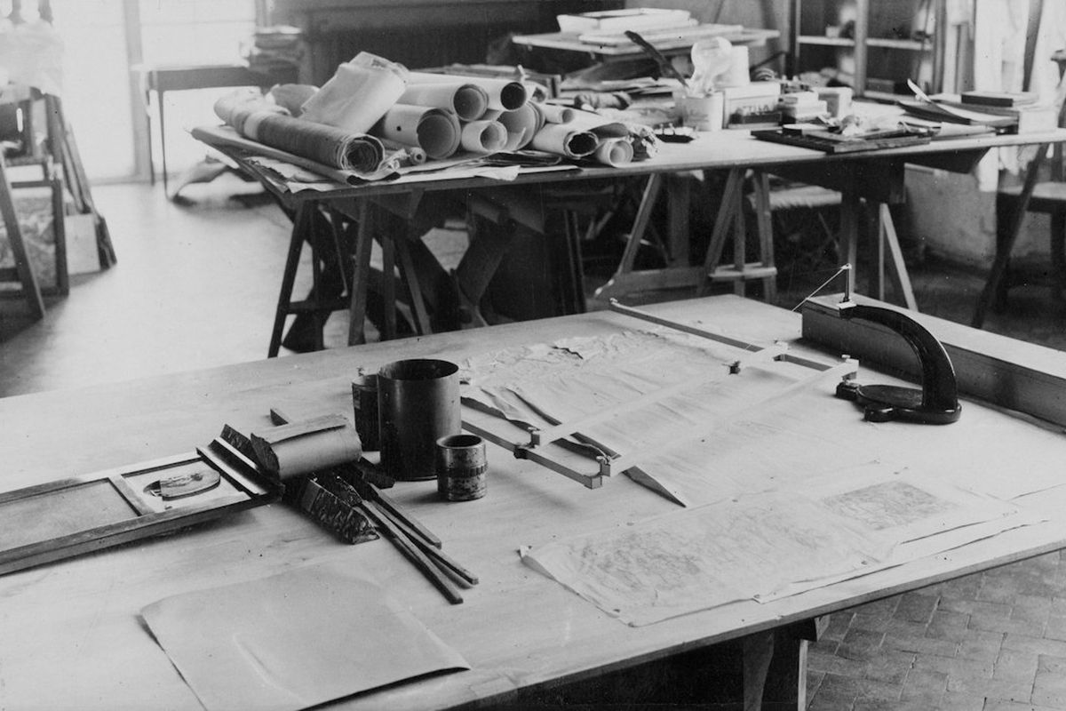 Event planning desk with a floor plan sketch, unmarked chips and a fountain pen under warm light