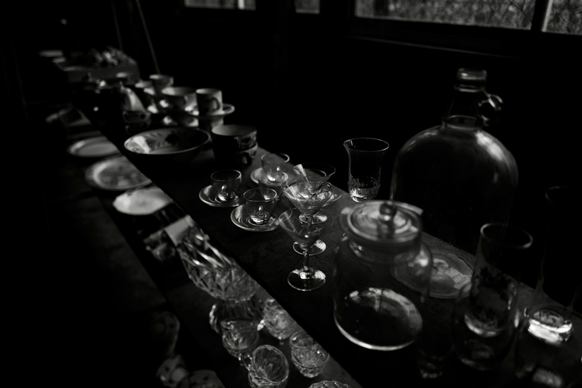 Long dinner table set for adults with a poker-themed centrepiece and candlelight