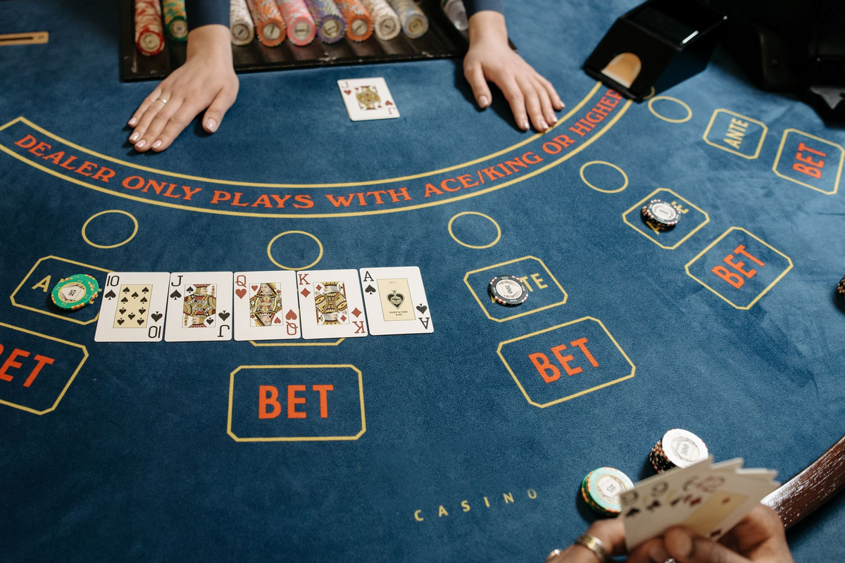 Casino-themed tables being levelled and dressed in an empty venue before guests arrive